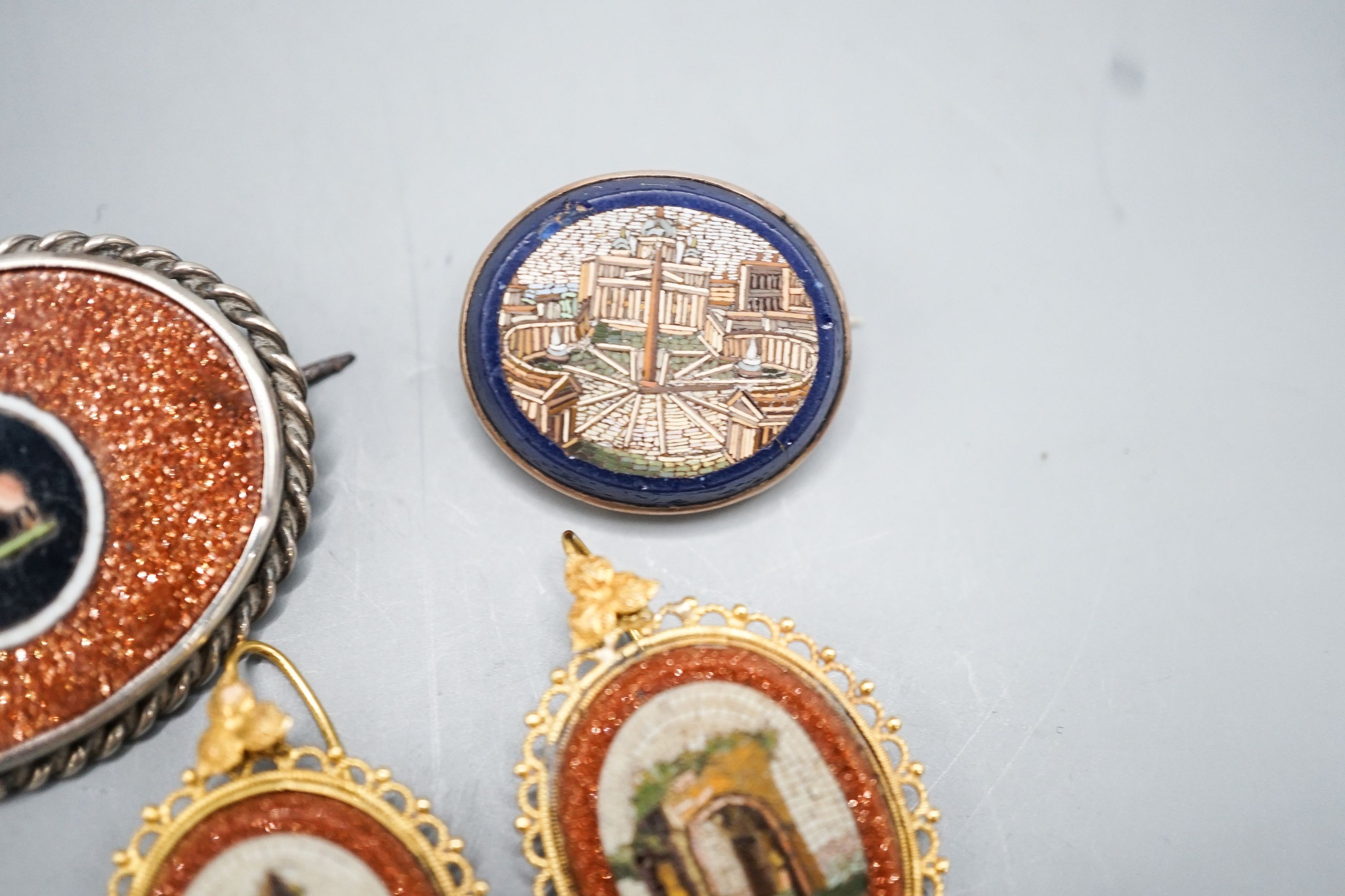 A pair of yellow metal mounted adventurine glass and micro mosaic oval earrings, decorated with ancient architecture, 32mm, a small micro mosaic oval brooch and a white metal mounted adventurine glass and micro mosaic ov